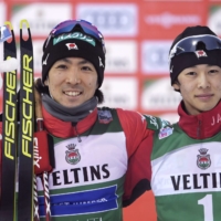 Akito Watabe (left) and Ryota Yamamoto celebrate on the podium after the Nordic combined 10-km cross country event in Lahti, Finland, on Sunday. | AFP-JIJI