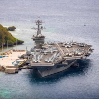 The USS Theodore Roosevelt aircraft carrier is moored pierside at Naval Base Guam last May. The carrier\'s strike group sailed into the South China Sea on a \"freedom of navigation\" exercise over the weekend, the first such operation in the region under new U.S. President Joe Biden.  | U.S. NAVY / VIA AFP-JIJI