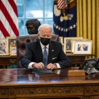 U.S. President Joe Biden signs an executive order at the White House on Monday.  | DOUG MILLS / THE NEW YORK TIMES
