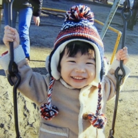 Kosuke, who died after malpractice at Tokyo Women\'s Medical University Hospital at age 2 in February 2014 and whose family name is being withheld, smiles on a swing in December 2013. | COURTESY OF KOSUKE\'S FAMILY / VIA KYODO