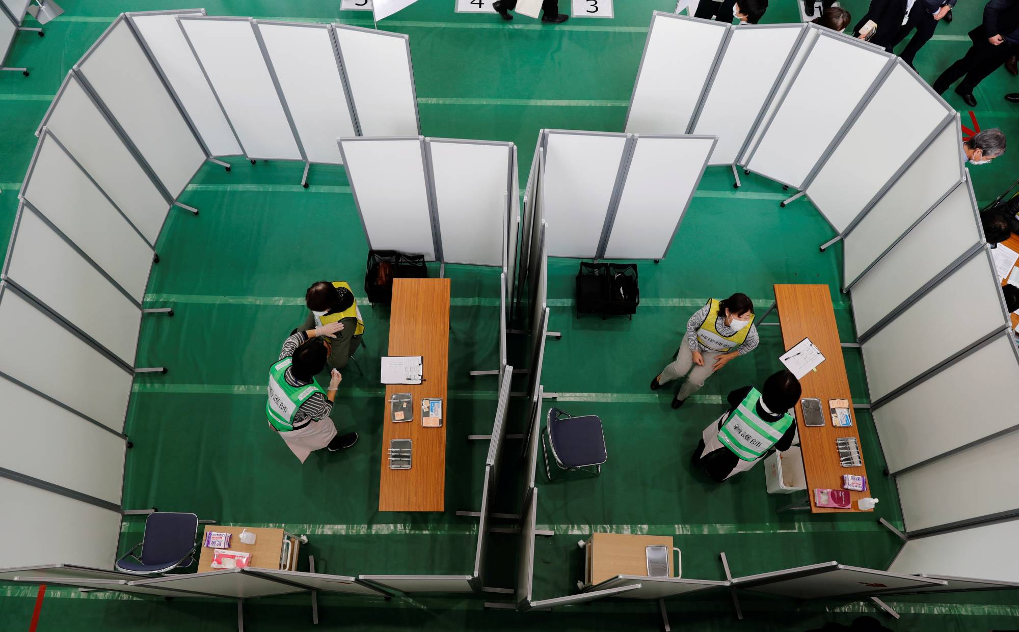 A mock inoculation exercise is held at a college gym in Kawasaki on Wednesday.  | REUTERS 