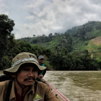 A team of Indonesian forest rangers makes its way along the Alas River, with signs of deforestation visible in the background. | AFP-JIJI