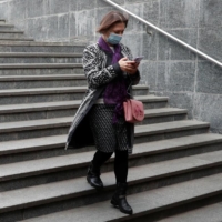 A woman uses her smartphone while walking into an underpass in Kyiv, Ukraine, in October last year. European lawmakers voted last week for the creation of new legal rights for employees to switch off from work-related tasks and electronic communication outside of office hours without facing consequences. | REUTERS