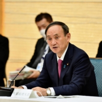 Prime Minister Yoshihide Suga speaks during a meeting about coronavirus control measures in Tokyo on Jan. 22.  | POOL / VIA REUTERS