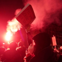 People take part in a protest against the verdict restricting abortion rights, in Warsaw on Thursday. | REUTERS