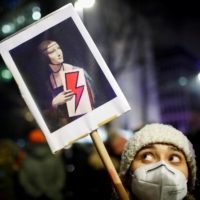 A demonstrator holds a placard during a protest against a verdict restricting abortion rights, in Warsaw on Thursday. | REUTERS