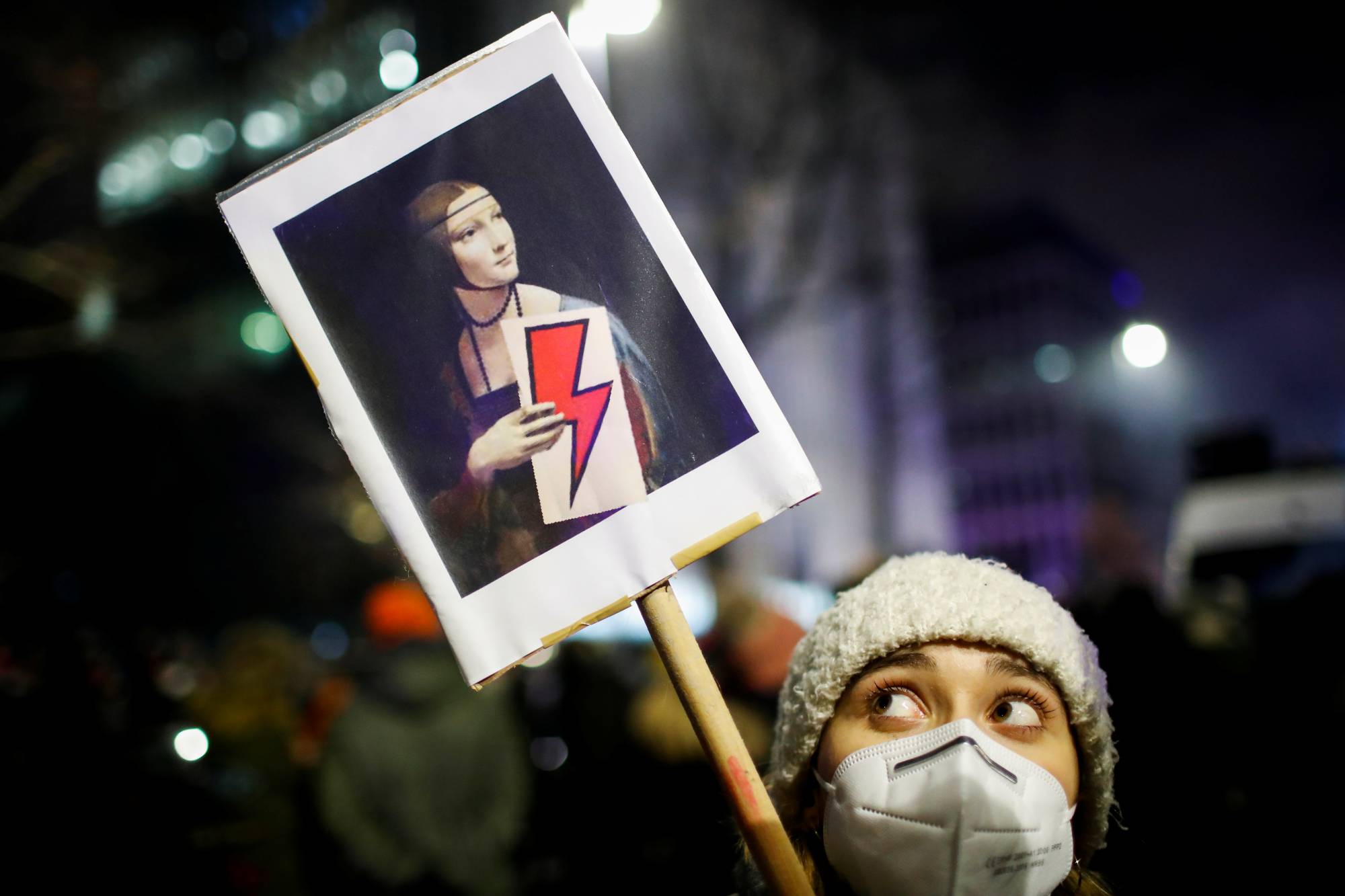 A demonstrator holds a placard during a protest against a verdict restricting abortion rights, in Warsaw on Thursday. | REUTERS