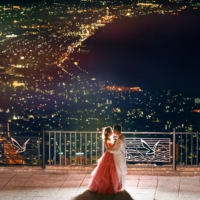 A Chinese couple pose for a wedding photo on Mount Hakodate in Hokkaido, with the lights of the city of Hakodate below. | COURTESY OF GLOVE ENTERTAINMENT 
