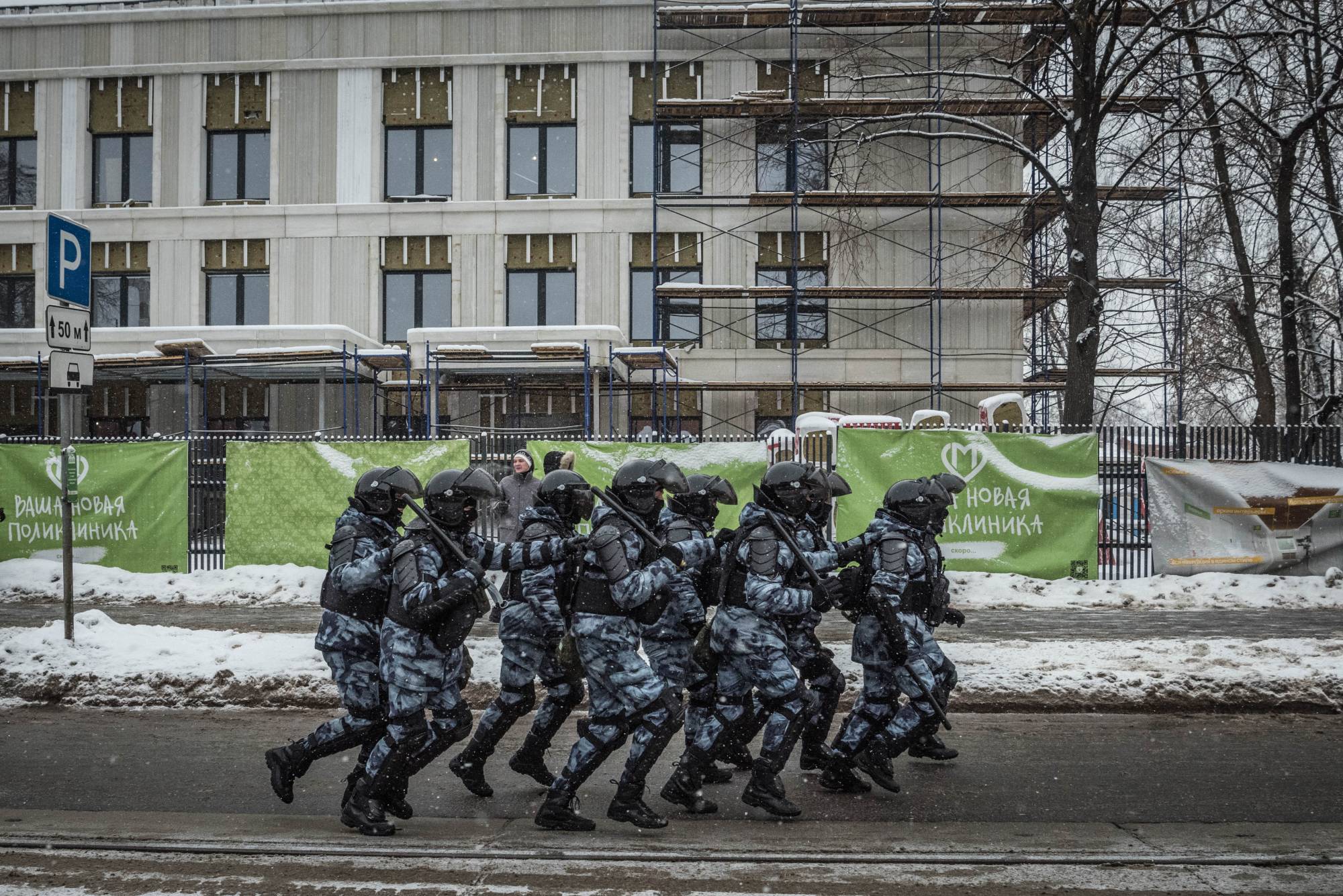 Police in riot gear jog to a position while working to seal off people at a rally in support of jailed Russian opposition leader Alexei Navalny in Moscow on Sunday. Tens of thousands of people who turned out across Russia on Sunday for a second consecutive weekend rally in support of Navalny were met by police in sometimes brutal clashes. | Sergey Ponomarev/The New York Times