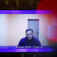 Russian opposition leader Alexei Navalny is seen on a screen via a video link during a court hearing to consider an appeal on his arrest outside Moscow on Thursday. | REUTERS