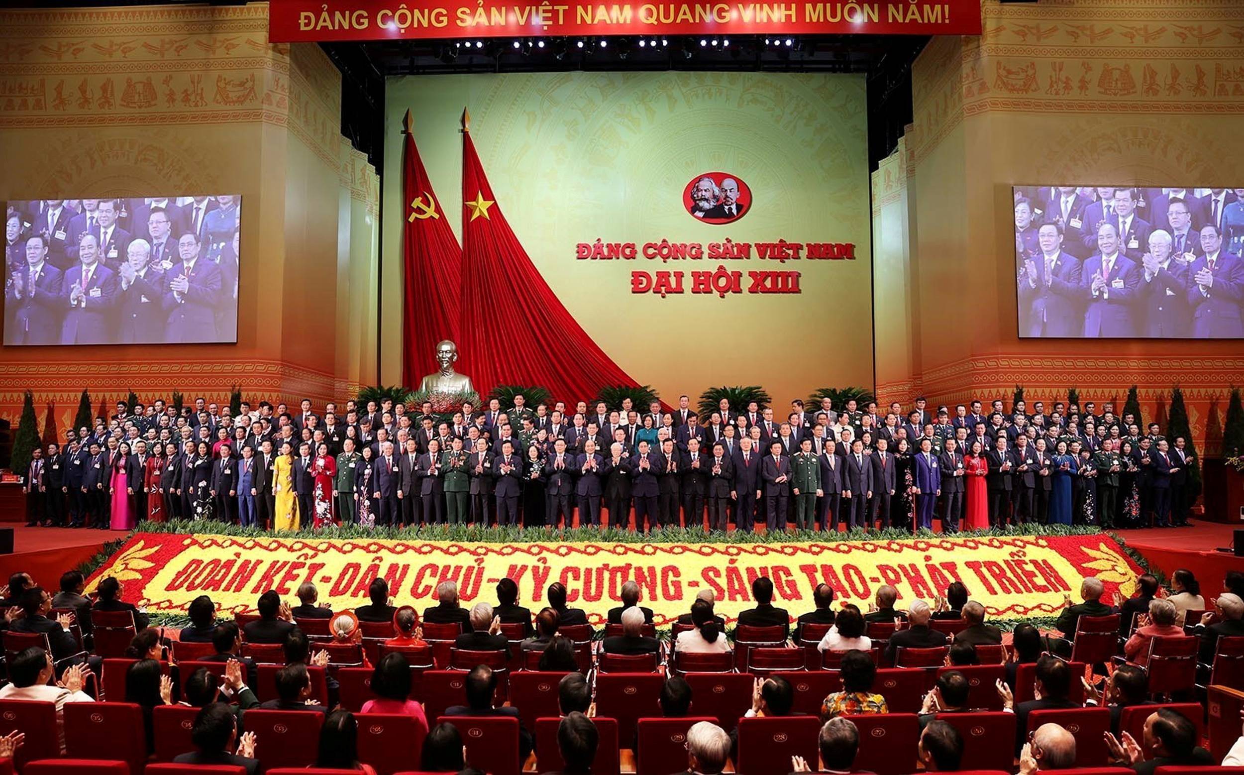 The Vietnamese Communist Party's new 200-member central committee poses at the closing ceremony of the 13th national congress of the ruling party in Hanoi on Monday. | VNA / VIA REUTERS
