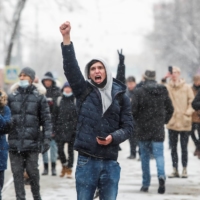 Protesters raise their fists during a rally in support of jailed Russian opposition leader Alexei Navalny in Moscow on Sunday. | REUTERS