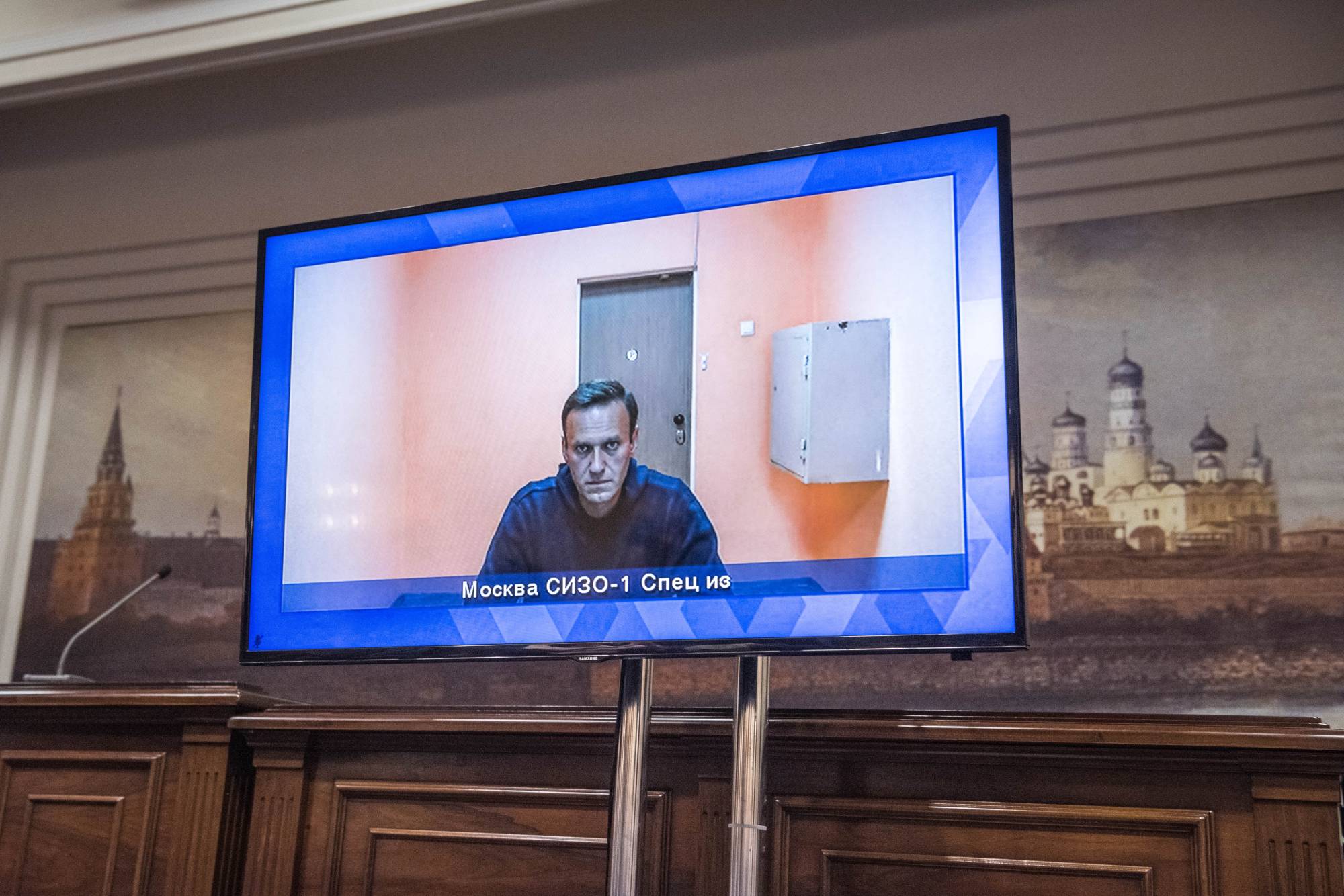 Alexei Navalny, the Russian opposition leader, on a television screen during his hearing in Moscow on Thursday. | Sergey Ponomarev/The New York Times