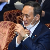 Prime Minister Yoshihide Suga attends a Lower House budget committee session at the Diet in Tokyo on Jan. 22. | AFP-JIJI