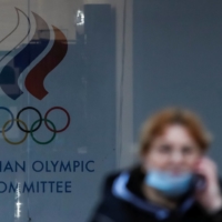 A woman walks by Russian Olympic Committee headquarters in Moscow on Nov. 2, 2020.  | REUTERS