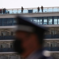 Passengers take in some fresh air on the Diamond Princess cruise ship in Yokohama on Feb. 21, 2020. | REUTERS