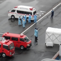 Medical teams wait to evacuate a passenger from the Diamond Princess cruise ship in February. | COURTESY OF ALAN SANFORD
