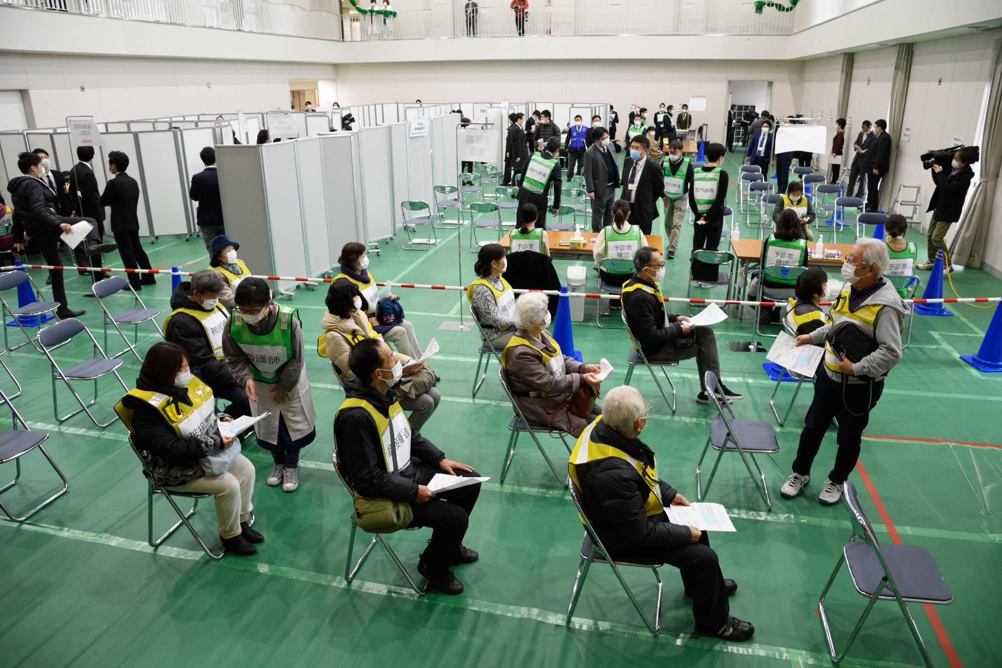 Volunteers take part in a vaccination simulation in Kawasaki in January. | BLOOMBERG