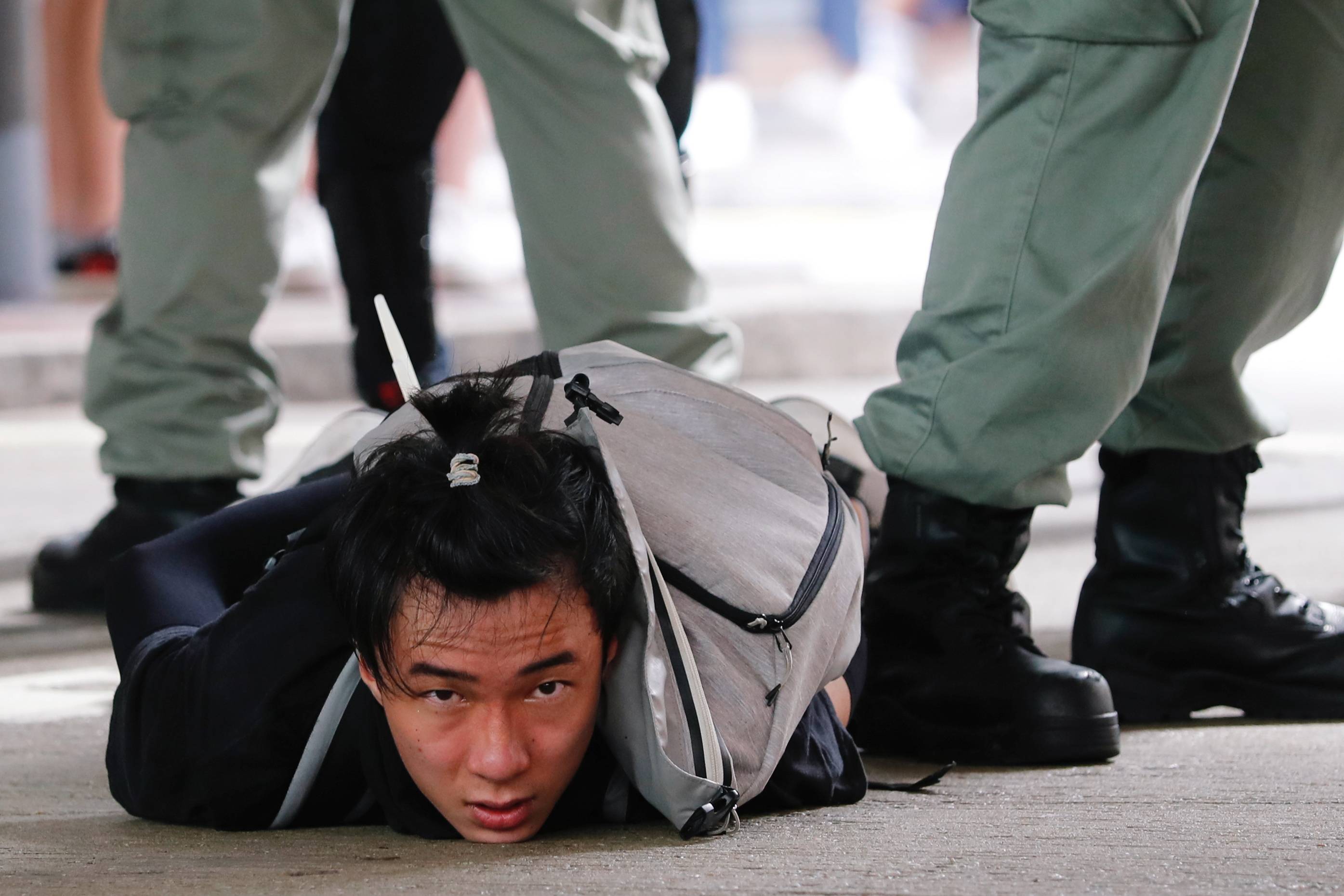 A man is detained by Hong Kong riot police during a march against the national security law on the anniversary of the city's handover to China from Britain on July 1, 2020. | REUTERS 