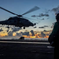 An MH-60R Sea Hawk helicopter launches during flight operations aboard the U.S. Navy aircraft carrier USS Ronald Reagan in the South China Sea in July 2020. | U.S. NAVY / VIA REUTERS