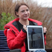 Sally Flavill shows a photograph of her nephew, Joseph Flavill, in Nottingham, England, on Friday. Joseph, 19, is slowly emerging from a coma, but has no knowledge of the coronavirus pandemic, which erupted after he was injured in a car accident in March last year. | REUTERS