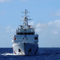 Chinese coast guard ships give chase to Vietnamese coast guard vessels (not pictured) after they came within 10 nautical miles of the Haiyang Shiyou 981 oil rig, known in Vietnam as HD-981, in the South China Sea in July 2014. | REUTERS