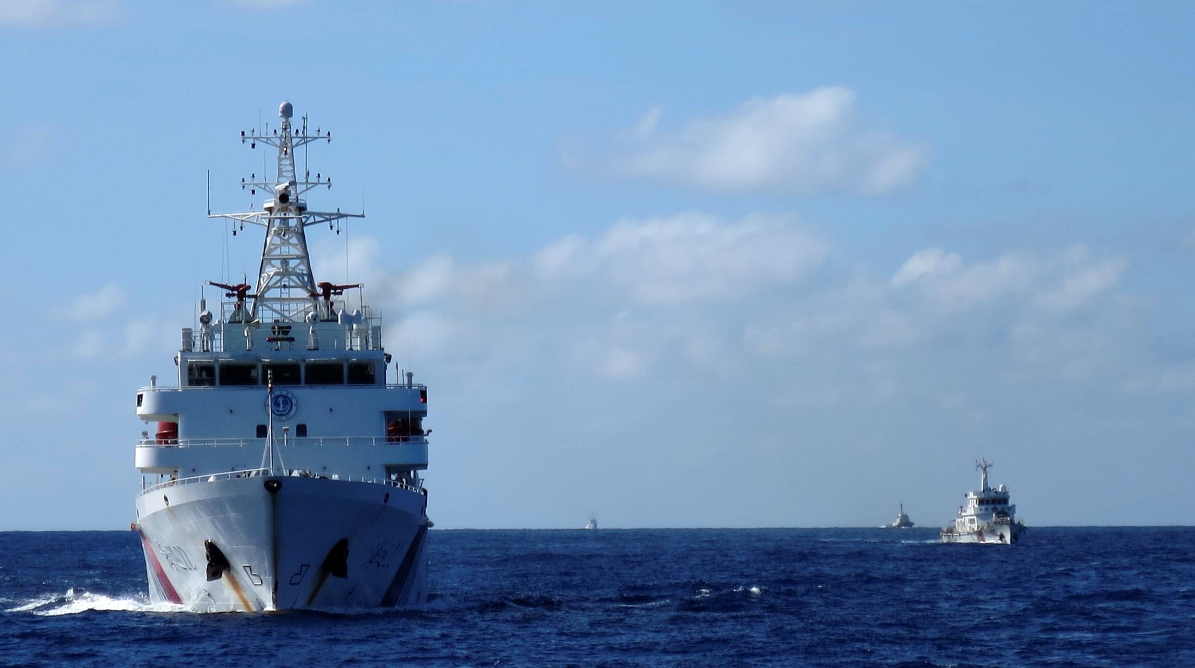 Chinese coast guard ships give chase to Vietnamese coast guard vessels (not pictured) after they came within 10 nautical miles of the Haiyang Shiyou 981 oil rig, known in Vietnam as HD-981, in the South China Sea in July 2014. | REUTERS
