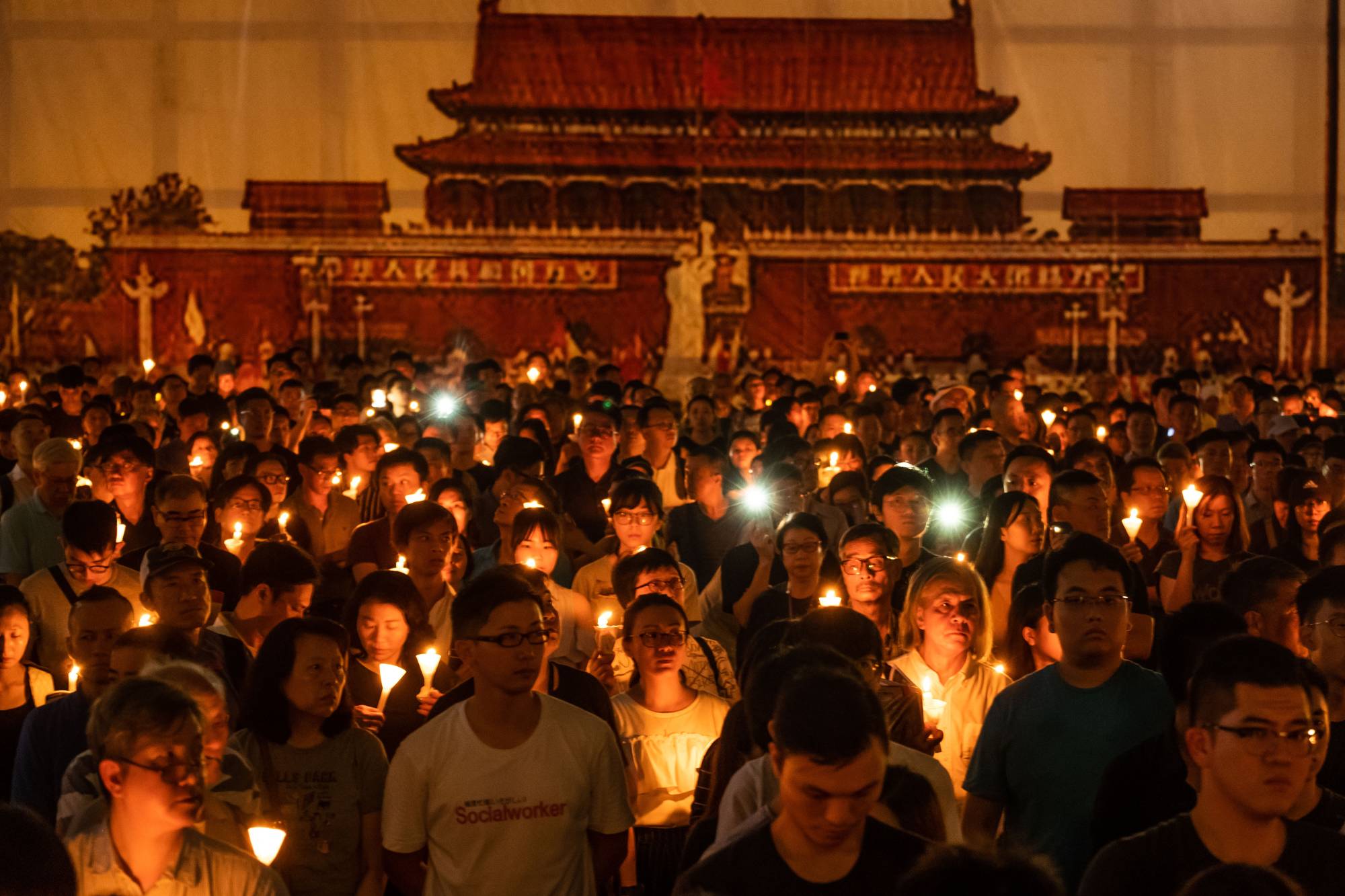 People take part in a candlelight vigil at Victoria Park in Hong Kong on June 4, 2019 to commemorate the protesters killed in Tiananmen Square 30 years before. | LAM YIK FEI / THE NEW YORK TIMES