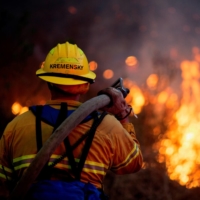 A firefighter battles the Blue Ridge Fire burning in Yorba Linda, California, on Oct. 26 last year.  | REUTERS