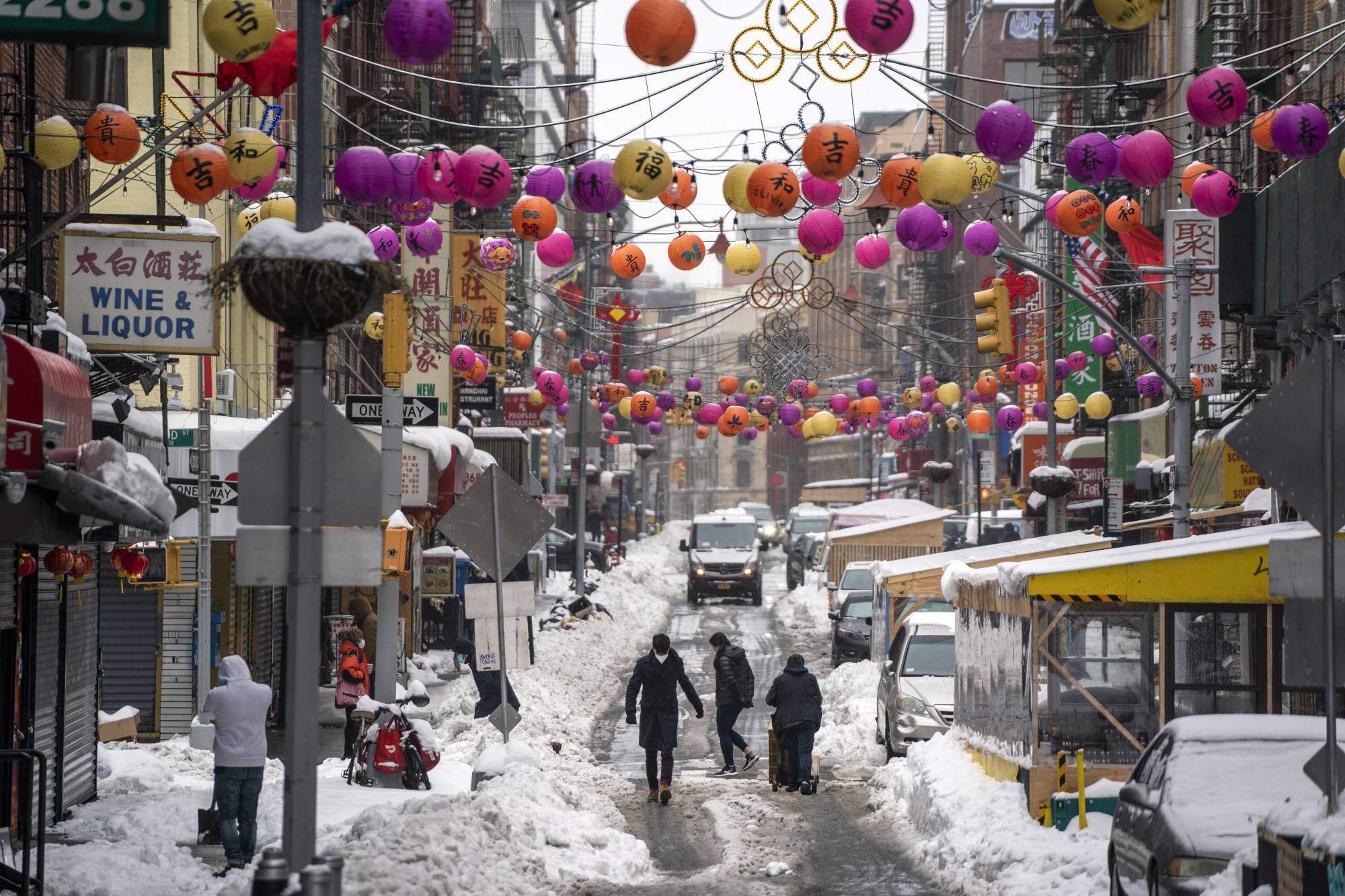 Pedestrians make their way through the Chinatown neighborhood of lower Manhattan, New York, on Feb. 2. | Todd Heisler / The New York Times