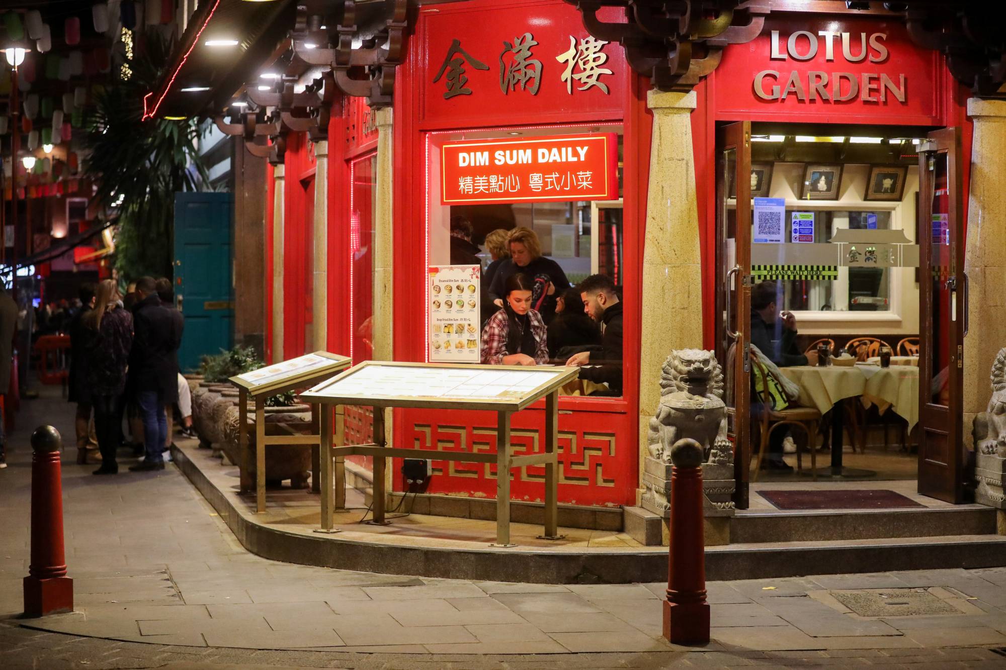 People eat at a restaurant in London's Chinatown on Dec. 5. | REUTERS