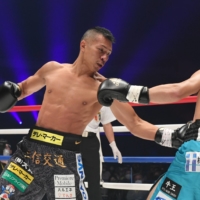 Takashi Uchiyama (left) lands a left against Kosuke Saka during their bout on Thursday. | COURTESY OF THE \"LEGEND\" EXECUTIVE COMMITTEE
