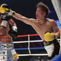 Naoya Inoue (right) attacks Daigo Higa during their headliner exhibition on Thursday at the \"Legend\" charity event. | COURTESY OF THE \"LEGEND\" EXECUTIVE COMMITTEE