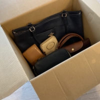 Brand-name bags and wallets packed in cardboard boxes waiting to be collected | SEINO TRANSPORTATION