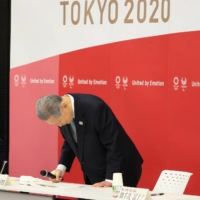Yoshiro Mori, president of the Tokyo Organizing Committee of the Olympic and Paralympic Games, announces his resignation Friday at the committee headquarters in Tokyo. | POOL / VIA REUTERS