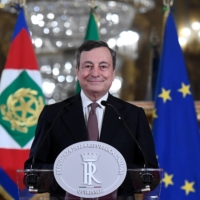 Mario Draghi, Italy\'s prime minister-designate, smiles at a news conference following a meeting with Italian President Sergio Mattarella in Rome on Friday. | ALESSANDRO DI MEO / ANSA / VIA BLOOMBERG