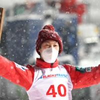 Ryoyu Kobayashi poses on the podium after winning a ski jumping World Cup competition on Saturday in Zakopane, Poland. | AFP-JIJI