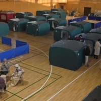 People spent the night at an evacuation center set up at a gymnasium in Soma, Fukushima Prefecture, following Saturday\'s strong quake. | KYODO