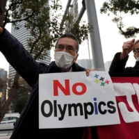Protesters call for the Tokyo Olympic and Paralympic Games to be cancelled, during a rally Friday in front of the offices of the Tokyo Organising Committee of the Olympic and Paralympic Games. | REUTERS