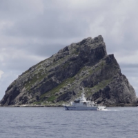 A Japan Coast Guard patrol ship sails around one of the Senkaku Islands in the East China Sea in September 2012.  | REUTERS
