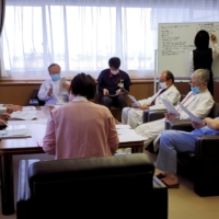 Manabu Yoneshima and other doctors attend a biweekly briefing about the COVID-19 situation at Municipal Tsuruga Hospital in Fukui Prefecture on Feb. 8. | REUTERS