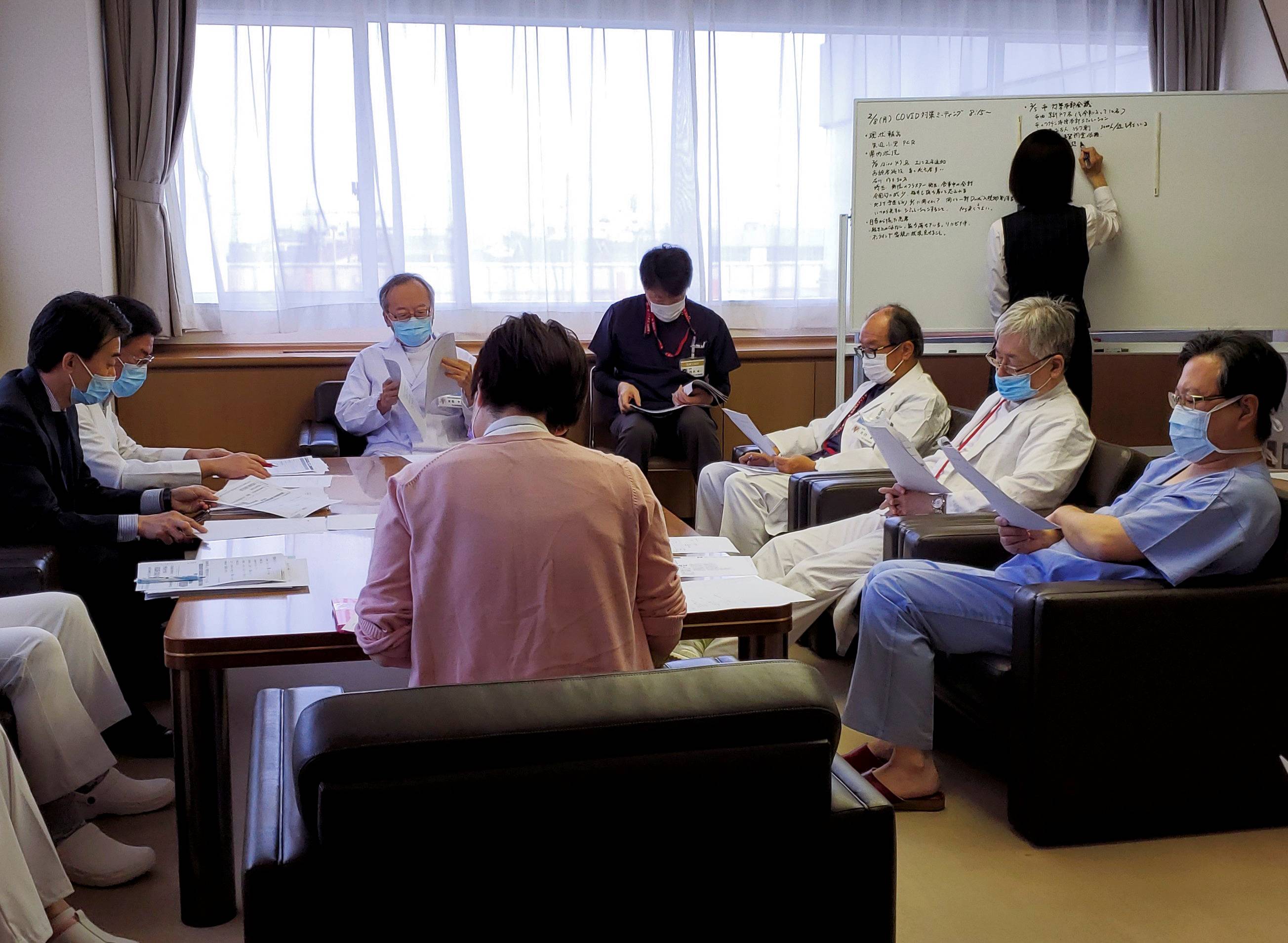 Manabu Yoneshima and other doctors attend a biweekly briefing about the COVID-19 situation at Municipal Tsuruga Hospital in Fukui Prefecture on Feb. 8. | REUTERS