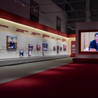 Chinese President Xi Jinping appears on a screen at an exhibition about China\'s fight against COVID-19.  | AFP-JIJI