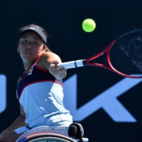 Yui Kamiji hits a return against Diede de Groot during the Australian Open women\'s wheelchair singles final in Melbourne on Wednesday. | AFP-JIJI