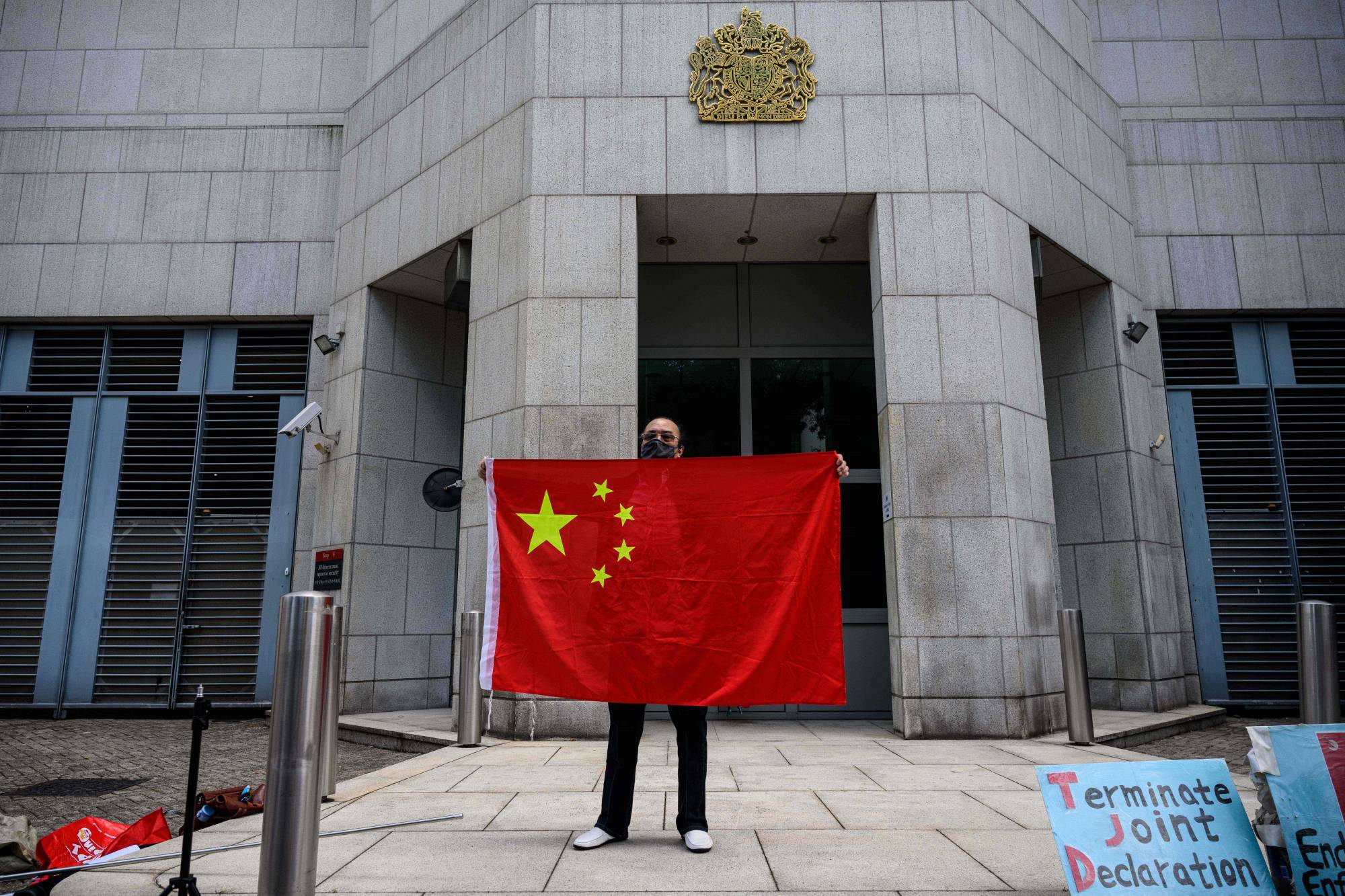 An activist holds the national flag of China outside the British Consulate-General in Hong Kong on Feb. 1. | AFP-Jiji