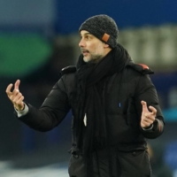 Manchester City manager Pep Guardiola directs his team during their match against Everton in Liverpool, England, on Wednesday. | POOL / VIA REUTERS