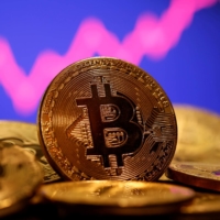 Bitcoin hit a market capitalization of $1 trillion as it rose to yet another record high on Friday, countering analyst warnings that it is an \"economic side show\" and a poor hedge against a fall in stock prices. | REUTERS