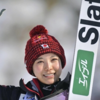 Sara Takanashi celebrates after her victory in a ski jumping World Cup event in Rasnov, Romania, on Friday.  | AP / VIA KYODO