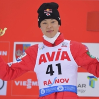 Ryoyu Kobayashi celebrates on the podium after winning the 18th World Cup title of his career in Rasnov, Romania, on Friday. | AP / VIA KYODO