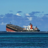 The MV Wakashio bulk carrier vessel, operated by Mitsui OSK Lines Ltd., sits partially submerged in the ocean after running aground close to Pointe d\'Esny, Mauritius, in August last year. | BLOOMBERG 